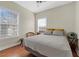 Cozy bedroom with two windows, natural light, and hardwood floors at 1160 Wilde Dr, Celebration, FL 34747