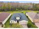 Aerial view of a home with a dark roof, brick driveway, and well-manicured lawn at 1398 Del Mar Dr, Kissimmee, FL 34759