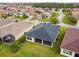 Aerial view of the back of a home with a screened-in lanai, adjacent to its neighbors at 1398 Del Mar Dr, Kissimmee, FL 34759