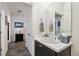 Cozy bathroom featuring a white vanity with black cabinets, neutral tile flooring, and decor at 1398 Del Mar Dr, Kissimmee, FL 34759