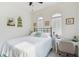 Bright bedroom featuring a comfortable bed, fan, arched windows, and charming wall decor at 1398 Del Mar Dr, Kissimmee, FL 34759