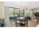 Bright dining room with a round wood table, tiled floor, and a sliding glass door to the backyard at 1398 Del Mar Dr, Kissimmee, FL 34759