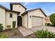 Beautiful house featuring brick driveway, two-car garage, arched windows, and manicured front yard at 1398 Del Mar Dr, Kissimmee, FL 34759