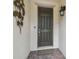 Close-up shot of the front door with brick paved entry and dark colored door at 1398 Del Mar Dr, Kissimmee, FL 34759