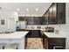 Bright kitchen boasts stainless steel appliances, dark wood cabinets, and white countertops at 1398 Del Mar Dr, Kissimmee, FL 34759