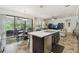 Open concept kitchen with stainless steel appliances, an island and view to the dining room at 1398 Del Mar Dr, Kissimmee, FL 34759