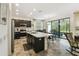 Well-lit kitchen with stainless steel appliances, a large island with a sink, and a view of the backyard at 1398 Del Mar Dr, Kissimmee, FL 34759