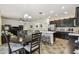 Open kitchen and dining area with stainless steel appliances, a breakfast bar, and dark wood cabinets at 1398 Del Mar Dr, Kissimmee, FL 34759