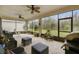 Relaxing screened lanai featuring comfortable seating and a variety of potted plants, bringing the outdoors in at 1398 Del Mar Dr, Kissimmee, FL 34759