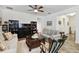 Bright living room featuring comfortable sofas, large window, ceiling fan, and rocking chair at 1398 Del Mar Dr, Kissimmee, FL 34759