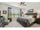 Cozy main bedroom with a dark wood bed frame, natural light, and neutral-toned decor at 1398 Del Mar Dr, Kissimmee, FL 34759