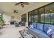 Relaxing screened-in patio with comfortable seating, ceiling fans, and outdoor grilling area at 1398 Del Mar Dr, Kissimmee, FL 34759