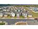 Aerial view showcasing a residential neighborhood with well-maintained homes and landscaping near a pond at 1669 Swan Swim Dr, Davenport, FL 33837