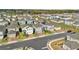 Aerial view of homes in a modern community, featuring well-maintained properties and a scenic backdrop at 1669 Swan Swim Dr, Davenport, FL 33837