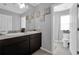 This bathroom offers double sinks, a large mirror, and a toilet in a separate alcove at 1669 Swan Swim Dr, Davenport, FL 33837