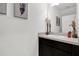 This bathroom features a vanity with a sink, decorative vases, and a large mirror at 1669 Swan Swim Dr, Davenport, FL 33837