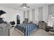 This bedroom offers a ceiling fan, soft carpet, and a view into the bathroom at 1669 Swan Swim Dr, Davenport, FL 33837