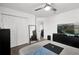This bedroom features a ceiling fan, a closet with white doors, and a full-length mirror at 1669 Swan Swim Dr, Davenport, FL 33837