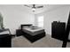Bedroom featuring a black bed frame, a ceiling fan, and neutral-toned carpet flooring at 1669 Swan Swim Dr, Davenport, FL 33837