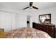 Bedroom featuring a patterned bedspread, a ceiling fan, and a wooden dresser at 1669 Swan Swim Dr, Davenport, FL 33837