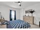 This bedroom provides a ceiling fan, soft carpet, and a large dresser for storage at 1669 Swan Swim Dr, Davenport, FL 33837