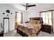 Bedroom featuring a patterned bedspread, side tables, and a ceiling fan at 1669 Swan Swim Dr, Davenport, FL 33837