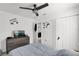 This bedroom has a ceiling fan, dresser with tv, and a closet with white doors at 1669 Swan Swim Dr, Davenport, FL 33837