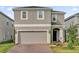 Charming two-story home with neutral paint, a two car garage and a well maintained, landscaped yard at 1669 Swan Swim Dr, Davenport, FL 33837