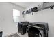 Neat laundry room with modern washer and dryer units and ample storage shelving at 1669 Swan Swim Dr, Davenport, FL 33837