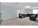 Open-concept living area featuring neutral walls, plush carpeting, with ample seating and natural light at 1669 Swan Swim Dr, Davenport, FL 33837