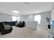 Spacious living room with plush carpeting, a modern ceiling fan, and comfortable seating for Gathering and friends at 1669 Swan Swim Dr, Davenport, FL 33837