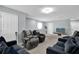 Comfortable living space with plush seating, neutral walls, carpet flooring, and an abundance of natural light at 1669 Swan Swim Dr, Davenport, FL 33837