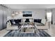 Bright and airy living room featuring plush seating, neutral walls, modern art, and decorative light fixtures at 1669 Swan Swim Dr, Davenport, FL 33837