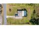 Aerial view of a home featuring a gravel driveway, large lawn and screened-in pool at 1741 Eldorado Ct, St Cloud, FL 34771