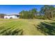 Large, well-maintained backyard, edged with mature trees, providing privacy and ample space for outdoor activities at 1741 Eldorado Ct, St Cloud, FL 34771