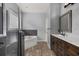 Bathroom with a soaking tub, separate shower, wood-look tile flooring, and dark wood vanity at 1741 Eldorado Ct, St Cloud, FL 34771