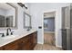 Modern bathroom with double sinks, dark wood cabinets, and a view into a bedroom at 1741 Eldorado Ct, St Cloud, FL 34771