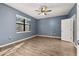 Bedroom with wood-look flooring, a ceiling fan, and natural light from the window at 1741 Eldorado Ct, St Cloud, FL 34771