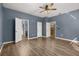 Spacious bedroom features wood-look flooring, a ceiling fan, and multiple doorways at 1741 Eldorado Ct, St Cloud, FL 34771