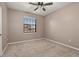 Neutral bedroom featuring a ceiling fan, carpet flooring, and a window with blinds at 1741 Eldorado Ct, St Cloud, FL 34771