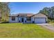 Charming single-story home featuring stone accents, a two-car garage, and a well-manicured lawn at 1741 Eldorado Ct, St Cloud, FL 34771