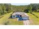 An aerial view of a charming single-story home with a two-car garage, a screened-in pool, and a large landscaped yard at 1741 Eldorado Ct, St Cloud, FL 34771