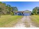 Inviting single-story home with stone accents, a two-car garage, and a sprawling front lawn at 1741 Eldorado Ct, St Cloud, FL 34771