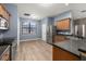 Well-lit kitchen featuring stainless steel appliances, wood cabinetry, and tile flooring at 1741 Eldorado Ct, St Cloud, FL 34771