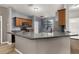 Modern kitchen with wood cabinets, granite countertops, and an open breakfast bar at 1741 Eldorado Ct, St Cloud, FL 34771