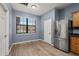 Eat in kitchen features stainless refrigerator, wood-look flooring, and natural light from the window at 1741 Eldorado Ct, St Cloud, FL 34771