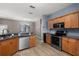Open kitchen featuring wood cabinets, stainless appliances, and view into the living area at 1741 Eldorado Ct, St Cloud, FL 34771