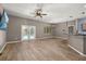 Open-concept living room with tile flooring, French doors to the pool, and a ceiling fan at 1741 Eldorado Ct, St Cloud, FL 34771