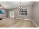 Bright living room with wood-look tile, TV, ceiling fan and view of the pool at 1741 Eldorado Ct, St Cloud, FL 34771