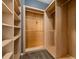 This spacious walk-in closet offers ample storage space with custom shelving and wooden rods at 1741 Eldorado Ct, St Cloud, FL 34771